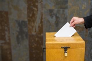 Wahlurne mit einem weißen Zettel 